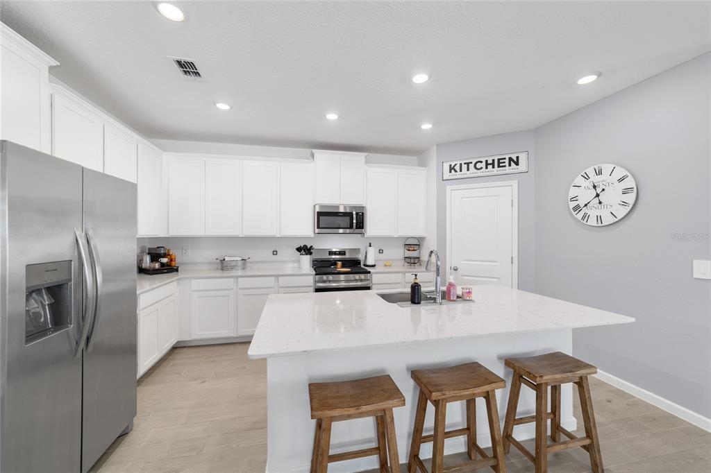 4012 Northeast 33rd Avenue Ocala, FL 34479 - Photo 22 of 77 a kitchen with a dining table cabinets stainless steel appliances and a counter top space