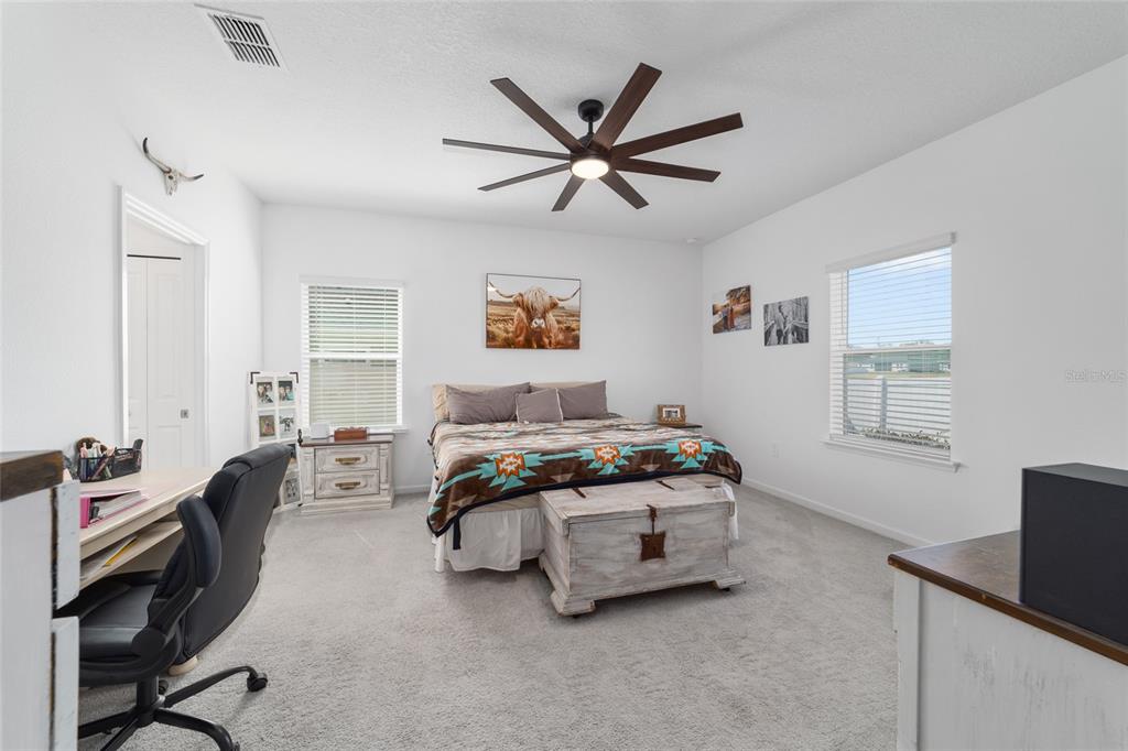 4012 Northeast 33rd Avenue Ocala, FL 34479 - Photo 29 of 77 a bedroom with a bed a couch and a window