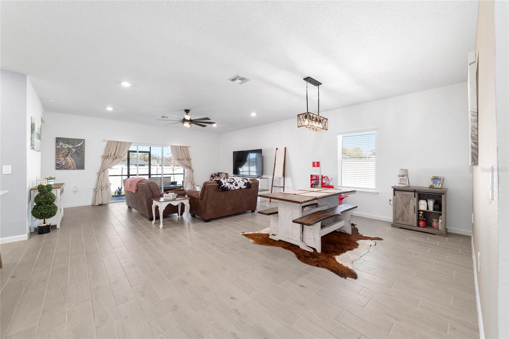 4012 Northeast 33rd Avenue Ocala, FL 34479 - Photo 6 of 77 a living room with furniture and a chandelier