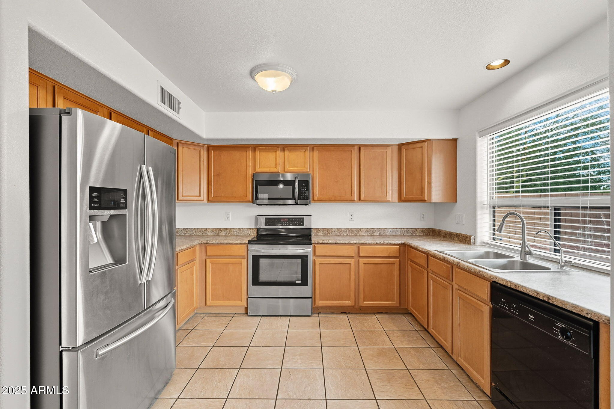 2503 West Gambit Trail Phoenix, AZ 85085 - Photo 12 of 54 a kitchen with stainless steel appliances granite countertop a refrigerator sink and stove