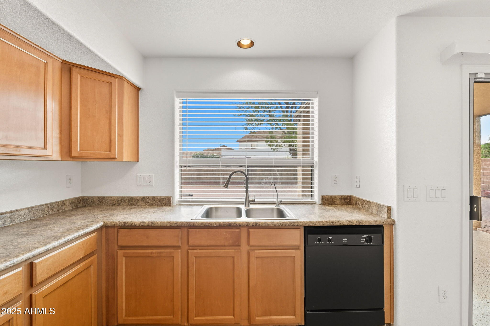 2503 West Gambit Trail Phoenix, AZ 85085 - Photo 14 of 54 a kitchen with granite countertop cabinets sink and window