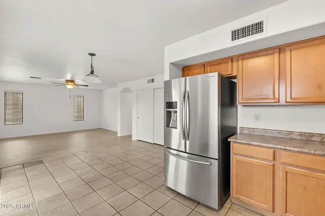 a kitchen with granite countertop cabinets sink and window