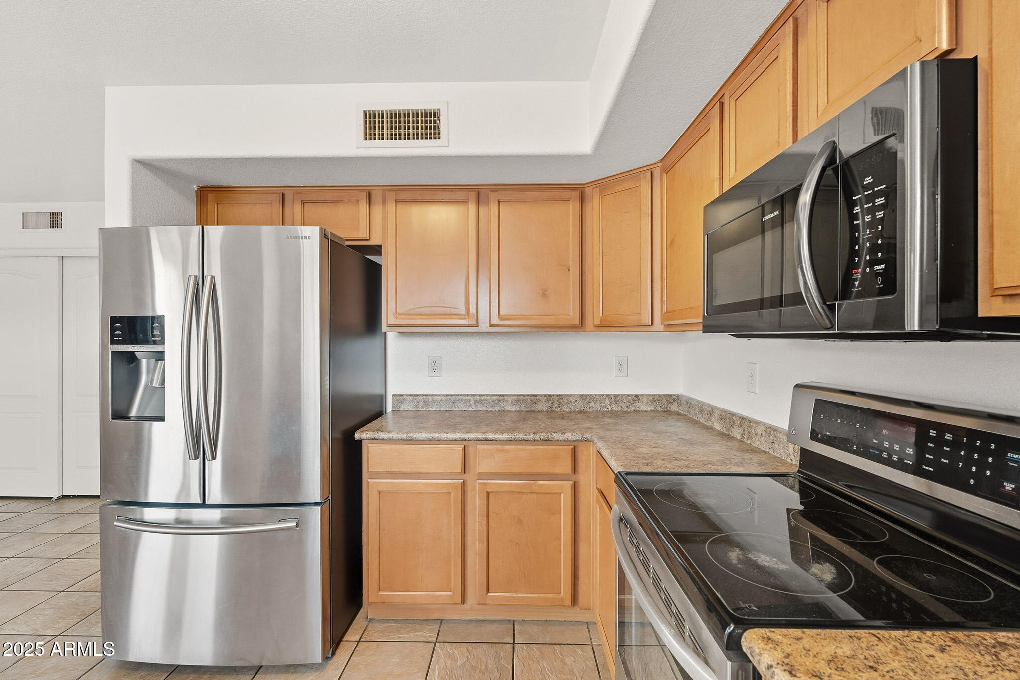 2503 West Gambit Trail Phoenix, AZ 85085 - Photo 16 of 54 a kitchen with stainless steel appliances granite countertop a refrigerator and a stove top oven