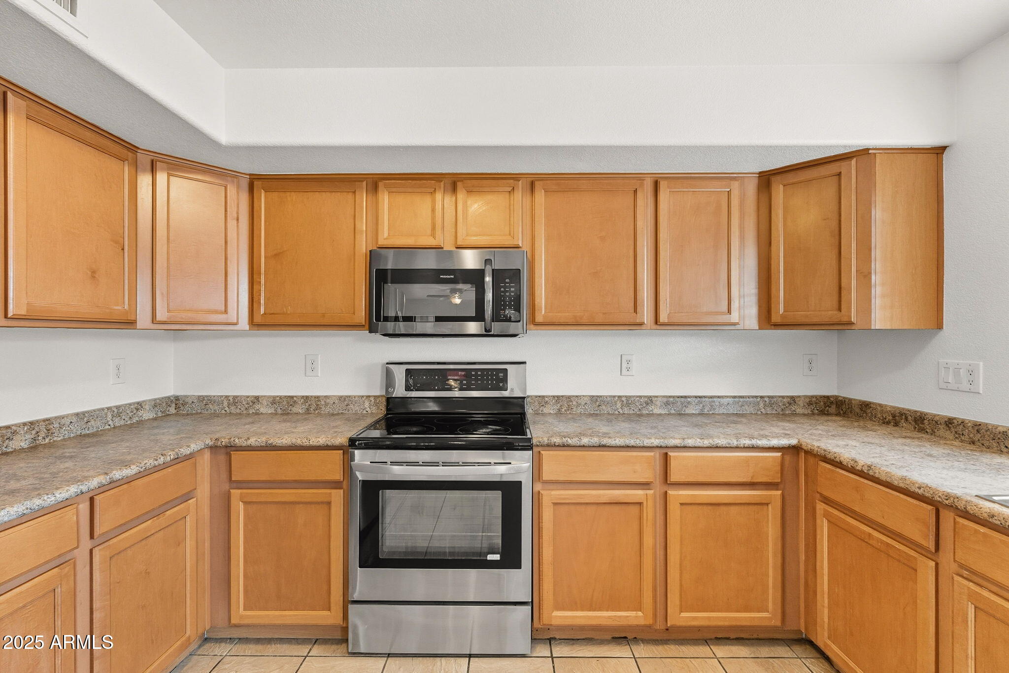 2503 West Gambit Trail Phoenix, AZ 85085 - Photo 17 of 54 a kitchen with stainless steel appliances granite countertop a stove a sink and a microwave