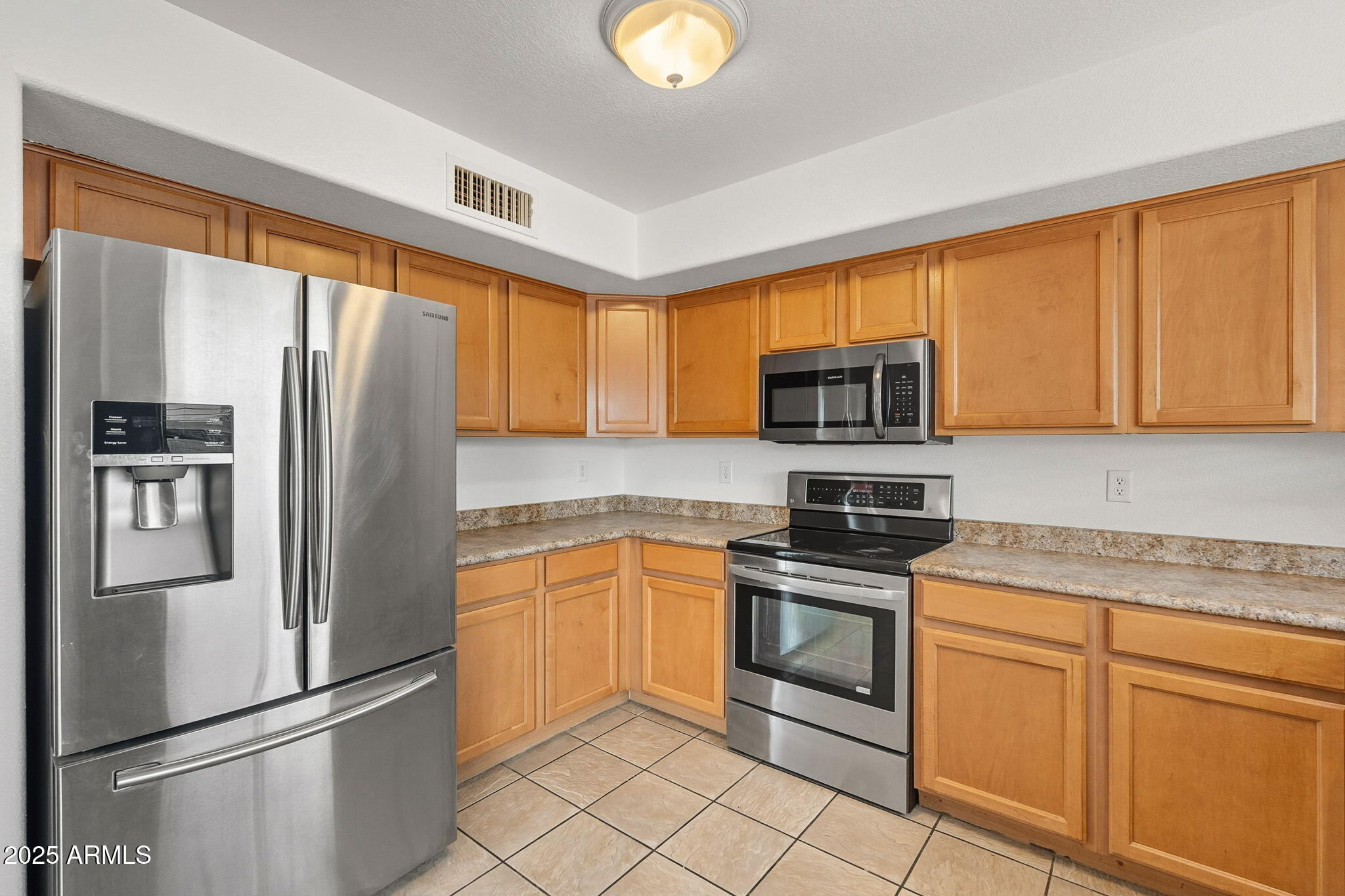2503 West Gambit Trail Phoenix, AZ 85085 - Photo 19 of 54 a kitchen with stainless steel appliances granite countertop a refrigerator microwave and sink
