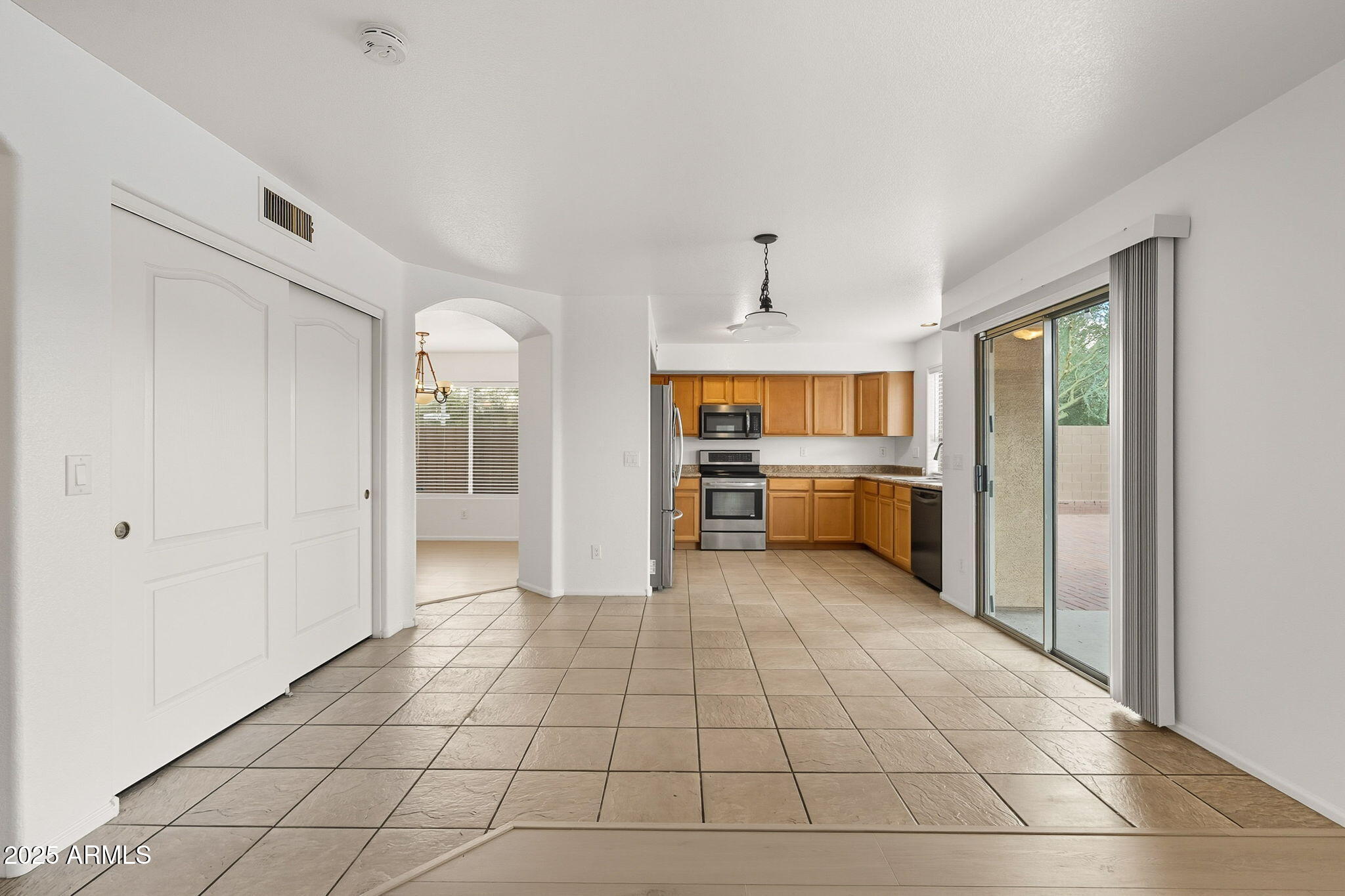 2503 West Gambit Trail Phoenix, AZ 85085 - Photo 20 of 54 a view of a kitchen with a sink and an empty room