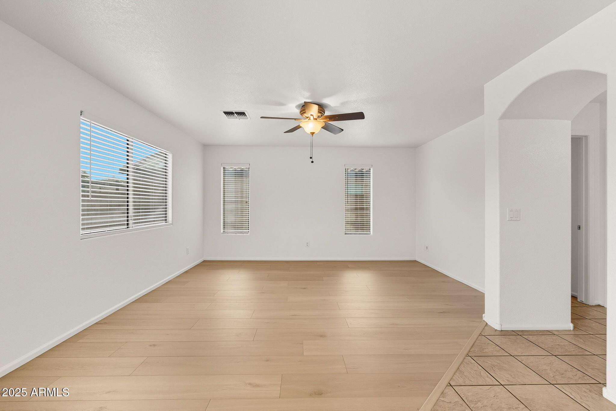 2503 West Gambit Trail Phoenix, AZ 85085 - Photo 21 of 54 a view of an empty room with chandelier fan and fire place