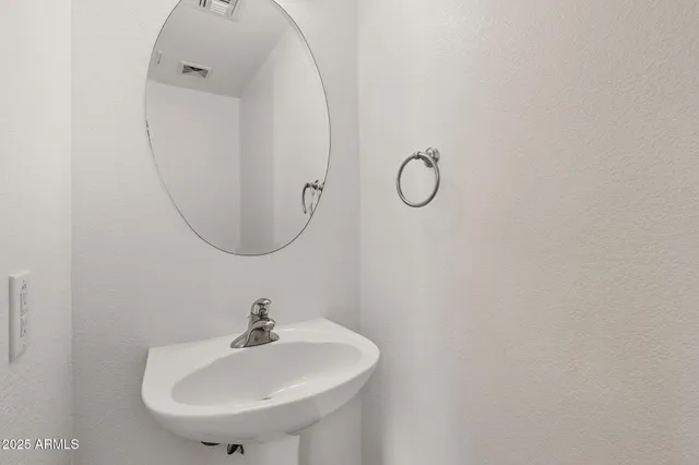 a view of an empty room with closet and a window