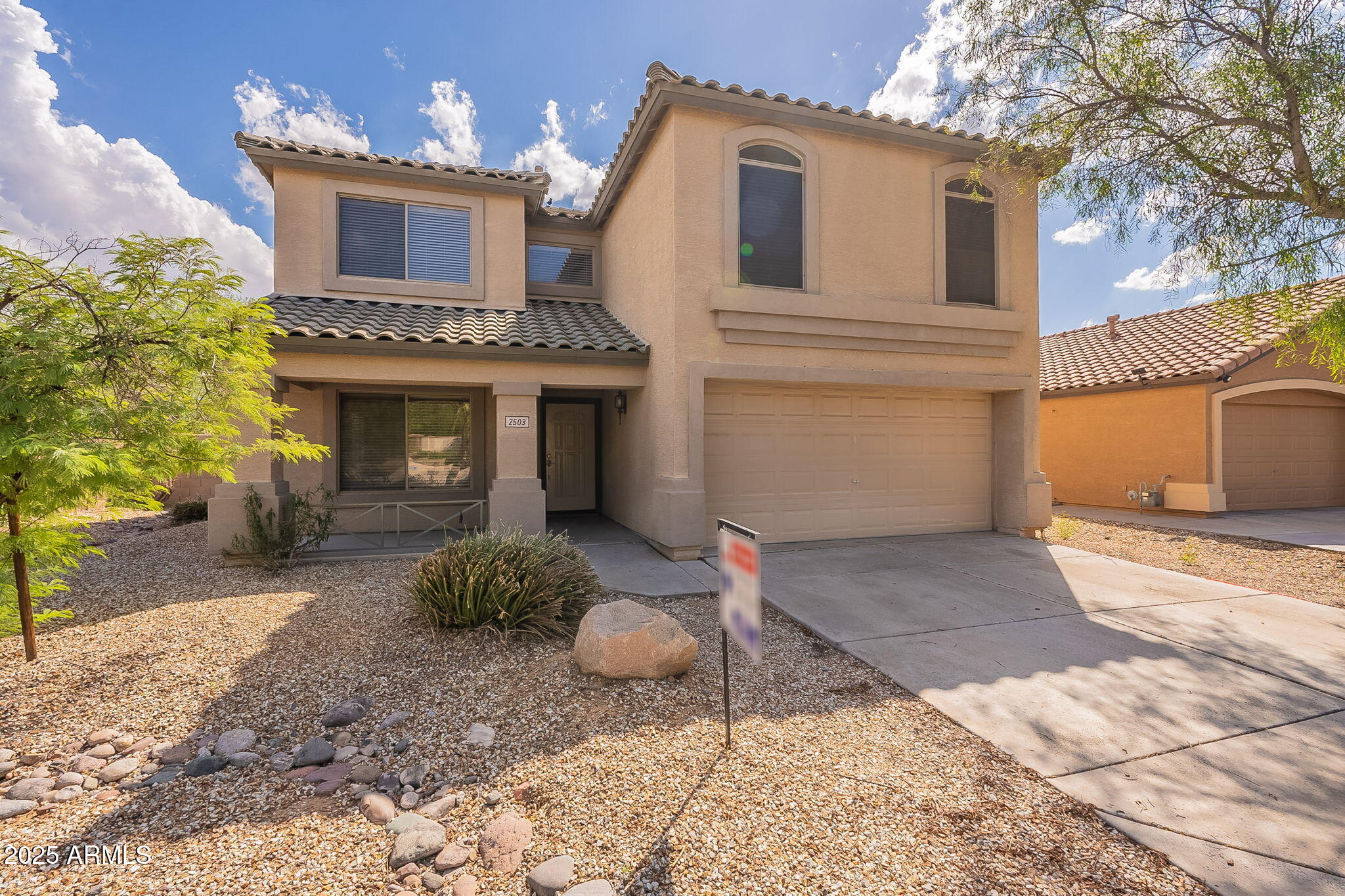 2503 West Gambit Trail Phoenix, AZ 85085 - Photo 2 of 54 a front view of a house with a yard and a garage