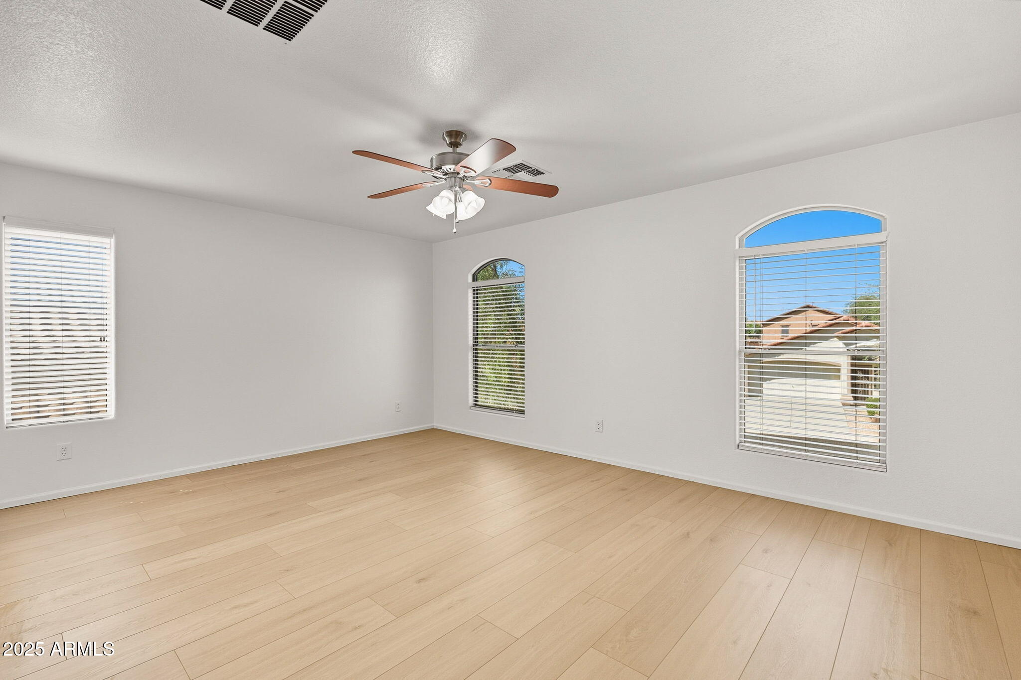 2503 West Gambit Trail Phoenix, AZ 85085 - Photo 30 of 54 an empty room with windows and ceiling fan