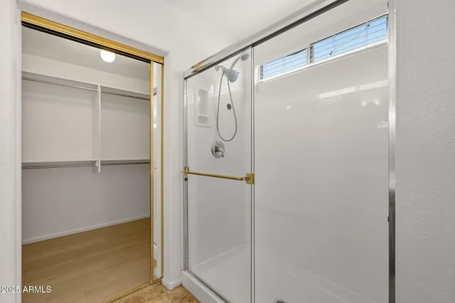 a bathroom with a glass shower door