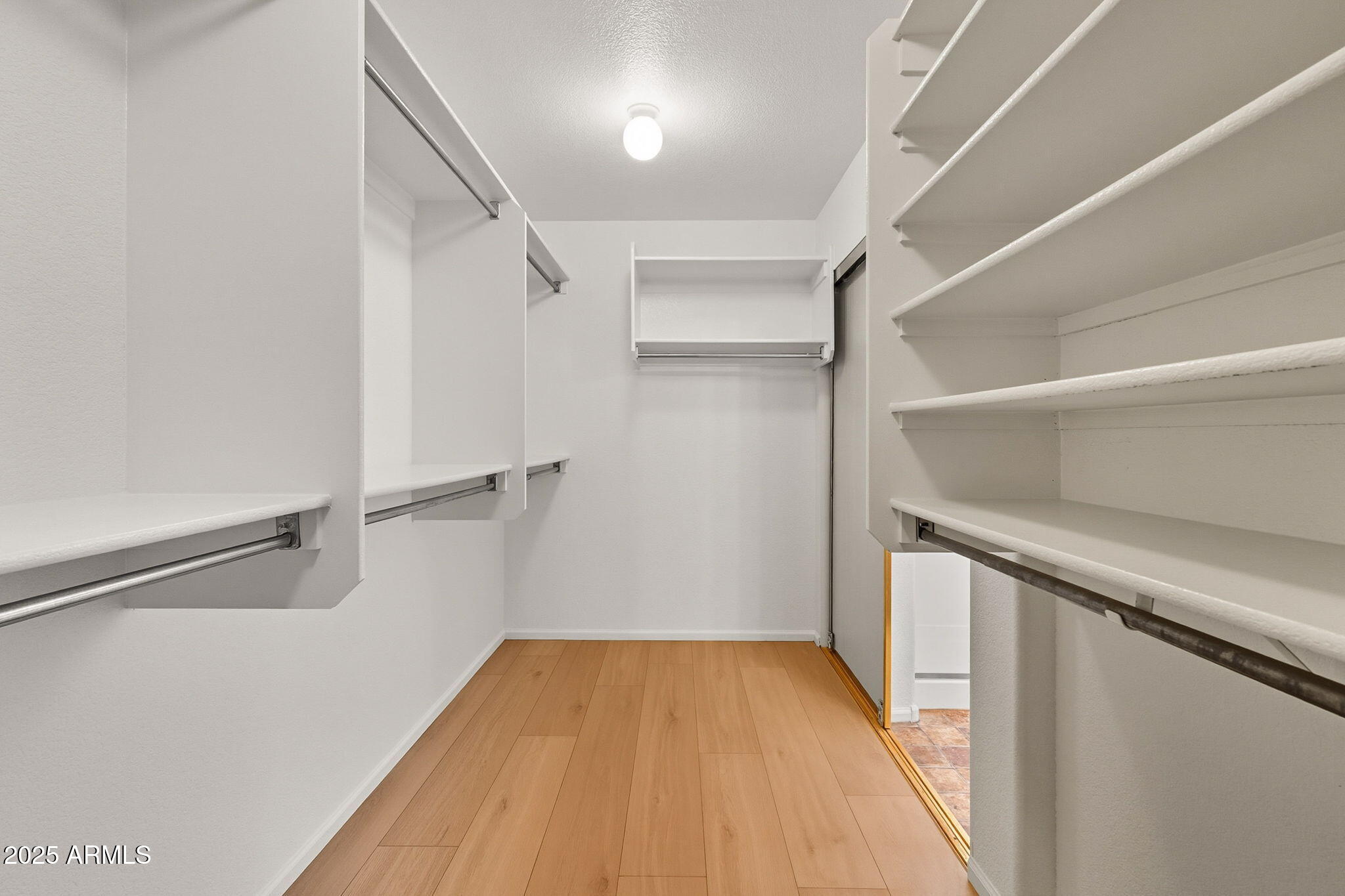 2503 West Gambit Trail Phoenix, AZ 85085 - Photo 37 of 54 a view of walk in closet with empty racks