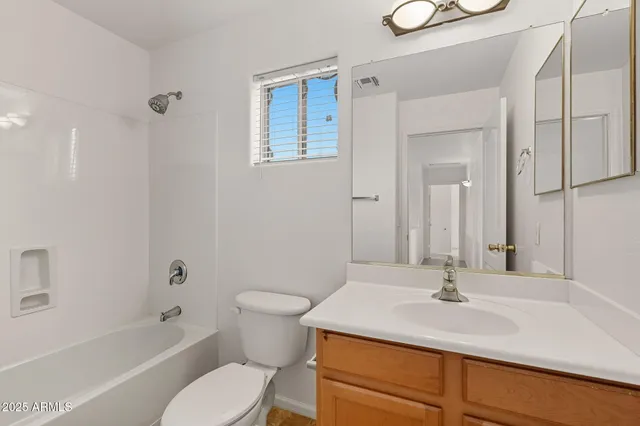 a bathroom with a sink toilet vanity and shower