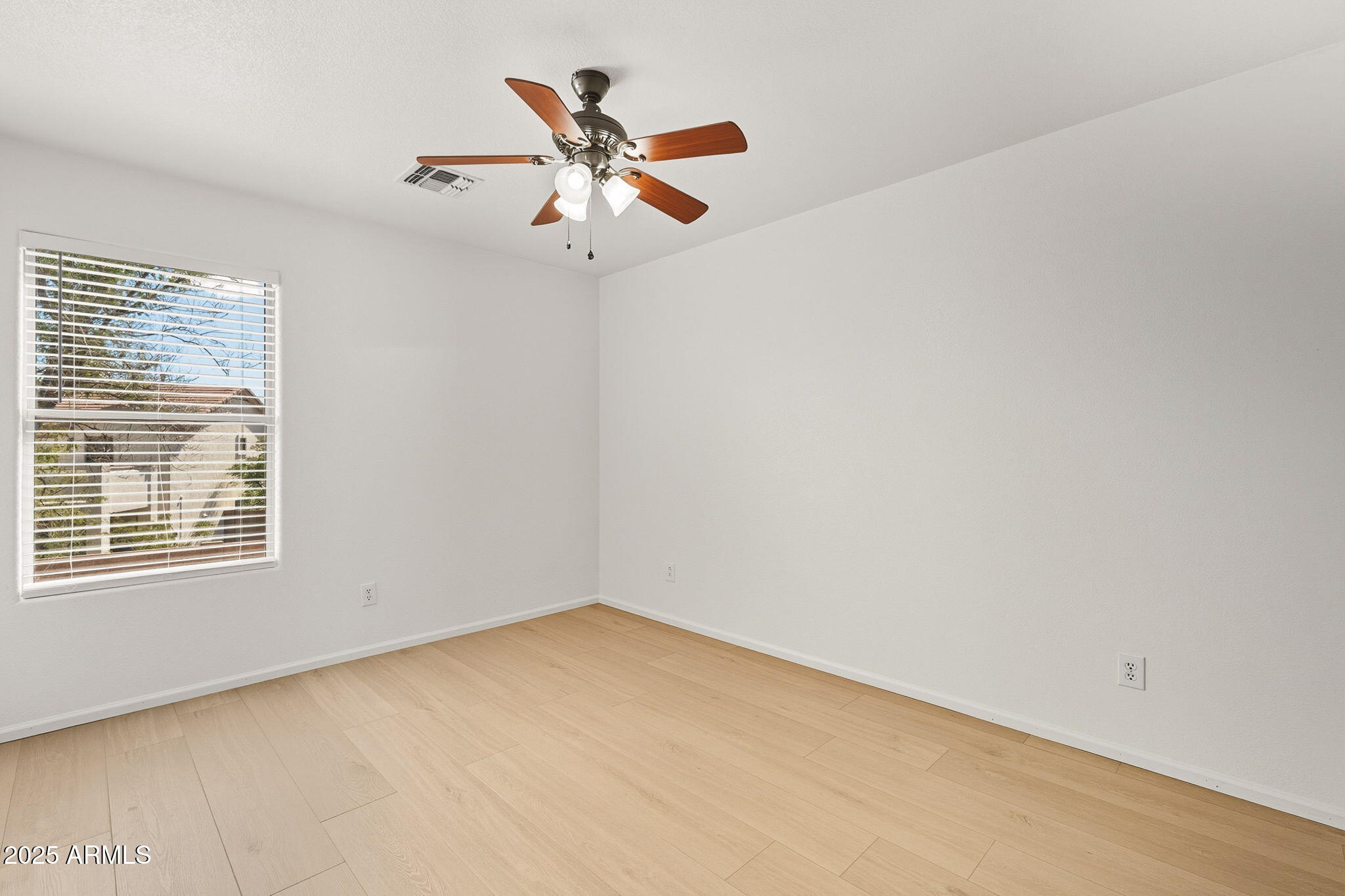 2503 West Gambit Trail Phoenix, AZ 85085 - Photo 43 of 54 an empty room with a window and a fan