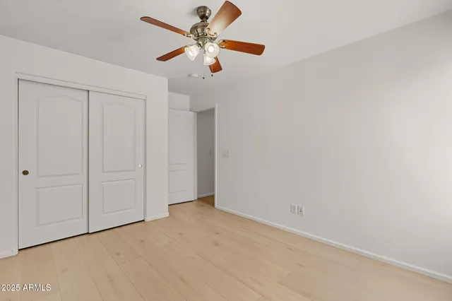 an empty room with a ceiling fan