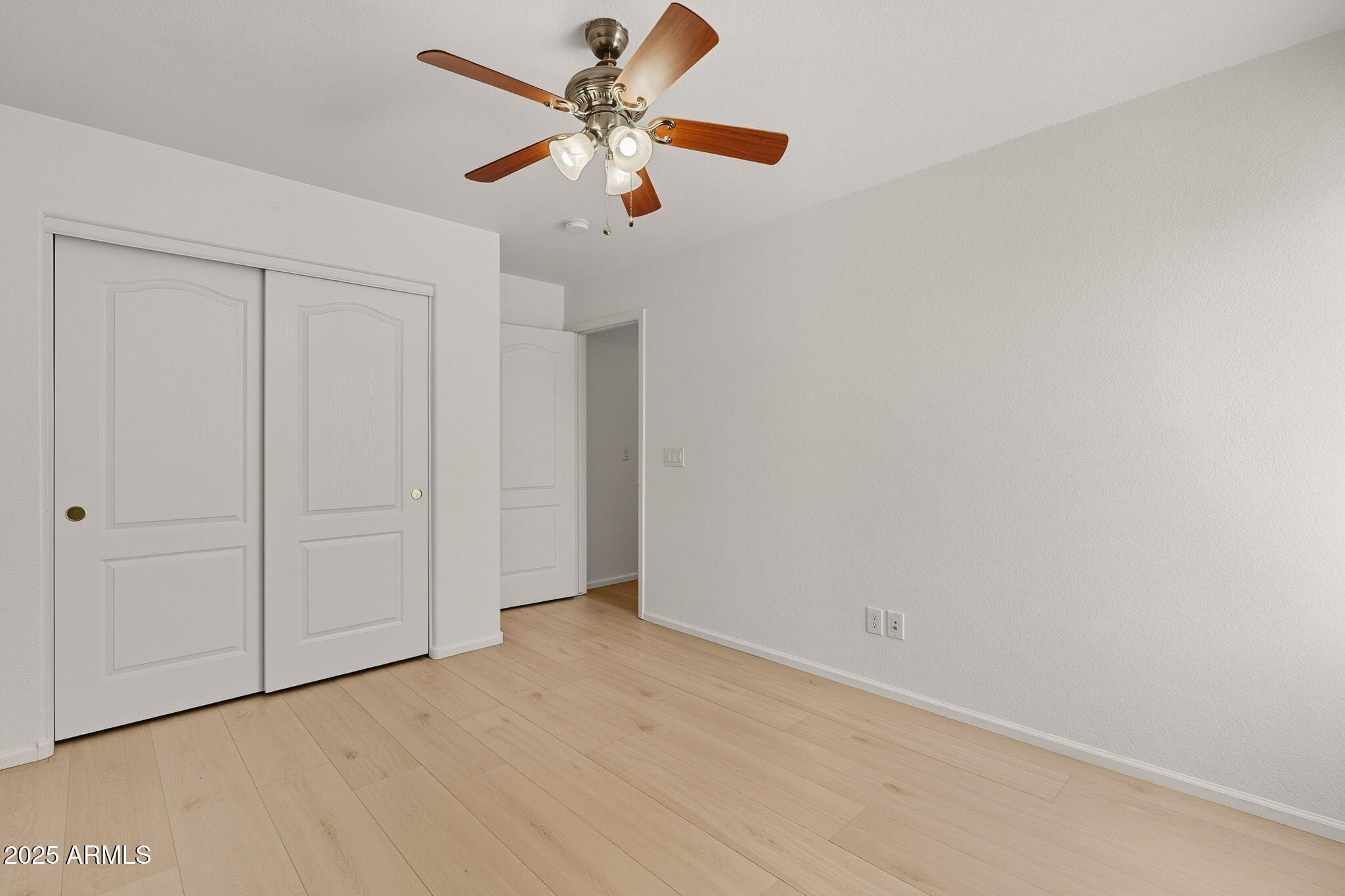 2503 West Gambit Trail Phoenix, AZ 85085 - Photo 44 of 54 an empty room with a ceiling fan