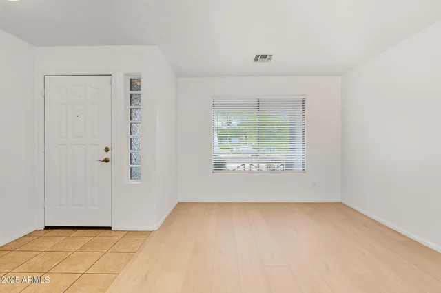 a view of an empty room with a window