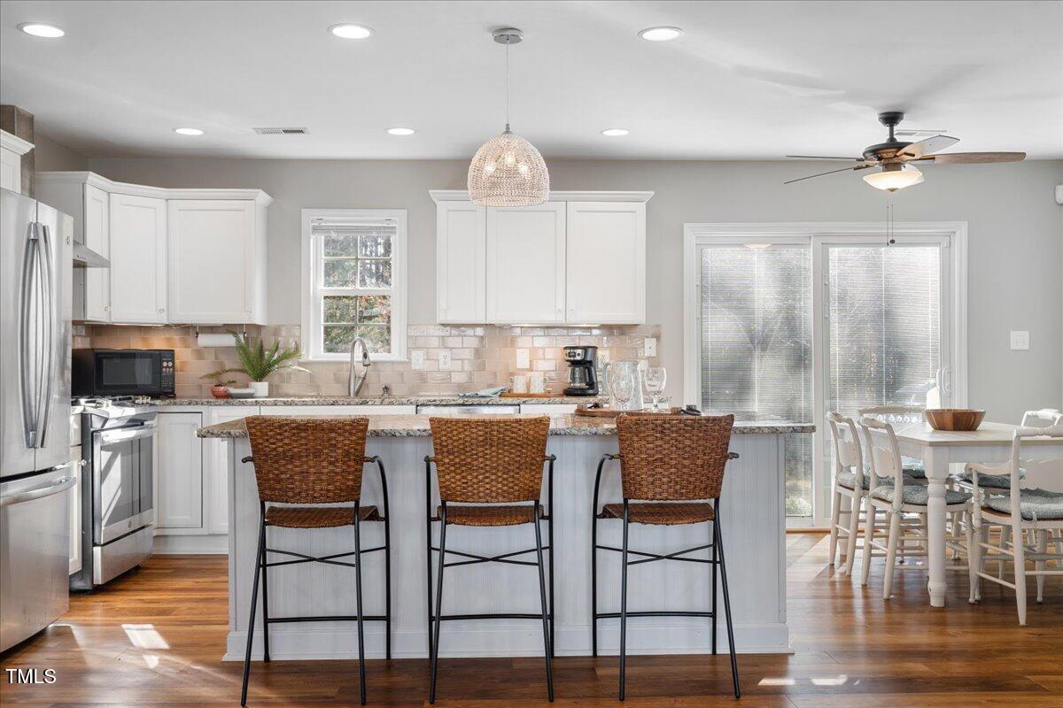 1171 Buck Street Road Roxboro, NC 27574 - Photo 11 of 63 a kitchen with stainless steel appliances granite countertop a table and chairs