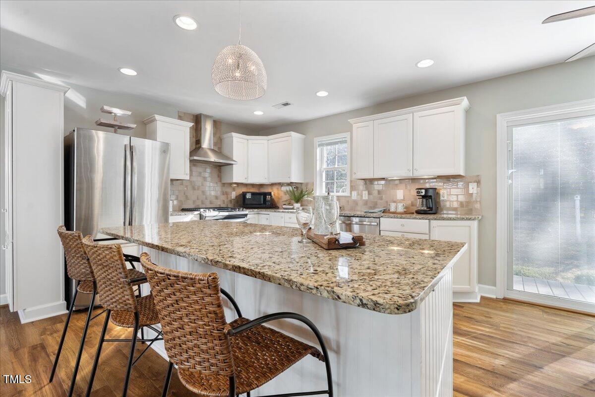 1171 Buck Street Road Roxboro, NC 27574 - Photo 14 of 63 a kitchen with stainless steel appliances granite countertop a sink refrigerator and cabinets