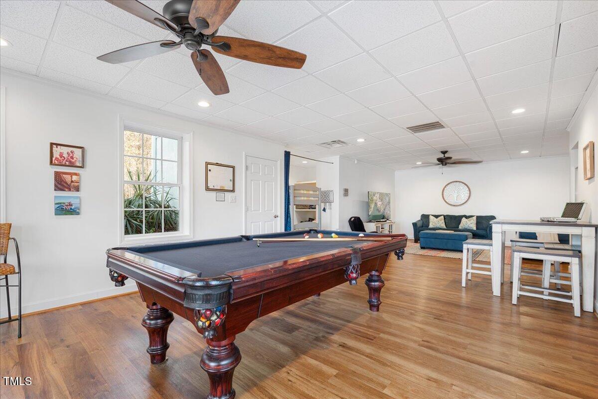 1171 Buck Street Road Roxboro, NC 27574 - Photo 29 of 63 a living room with furniture a wooden floor and chandelier
