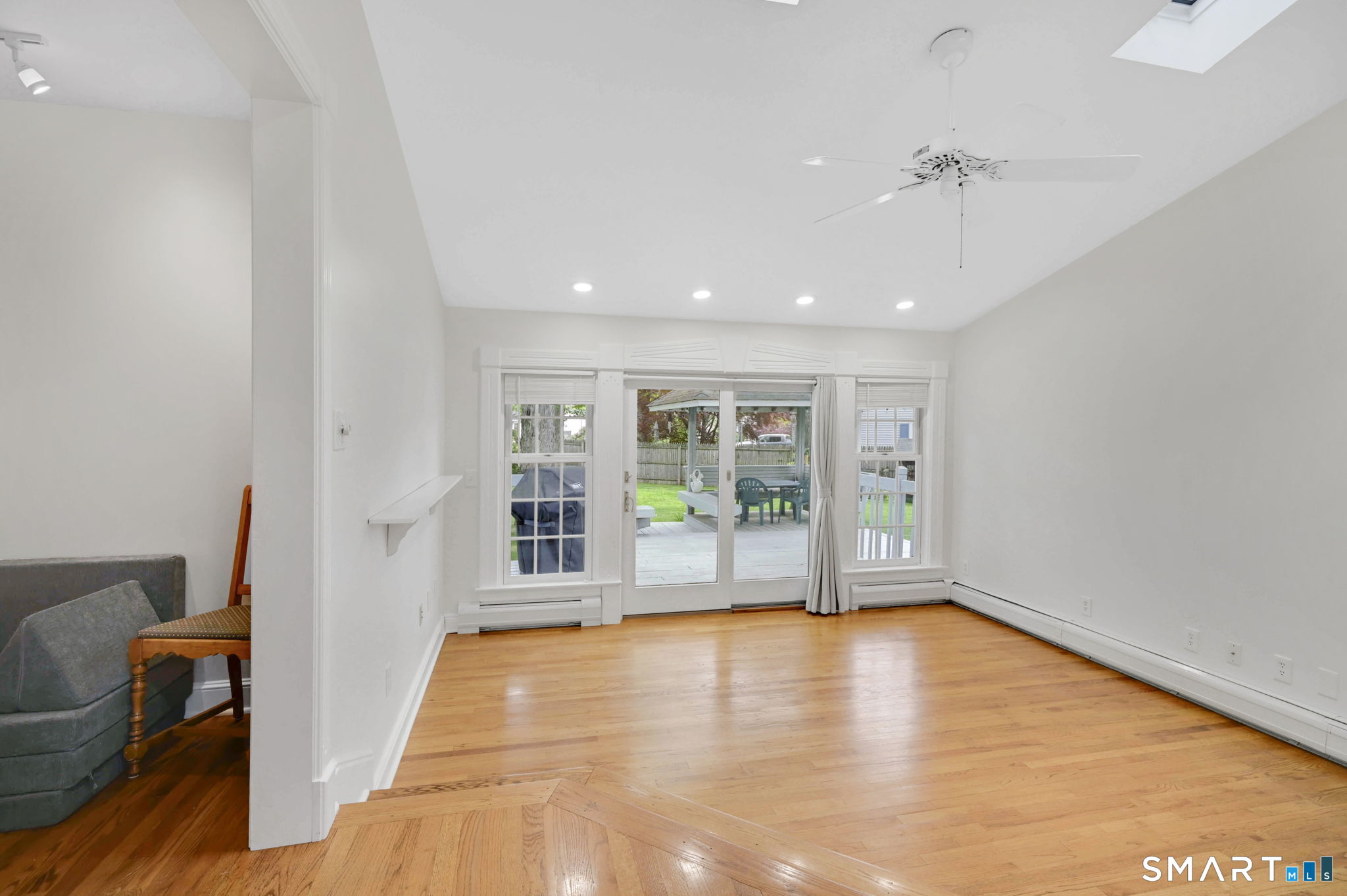 35 S Road Enfield, CT 06082 - Photo 10 of 40 Family room with vaulted ceiling, skylight, ceiling fan and sliders to deck.
