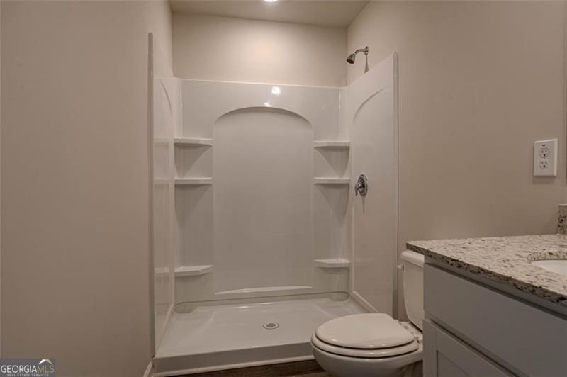 1005 North 2nd Avenue Northwest, Unit 31 Rome, GA 30165 - Photo 12 of 20 a bathroom with a granite countertop bathtub shower sink vanity and toilet