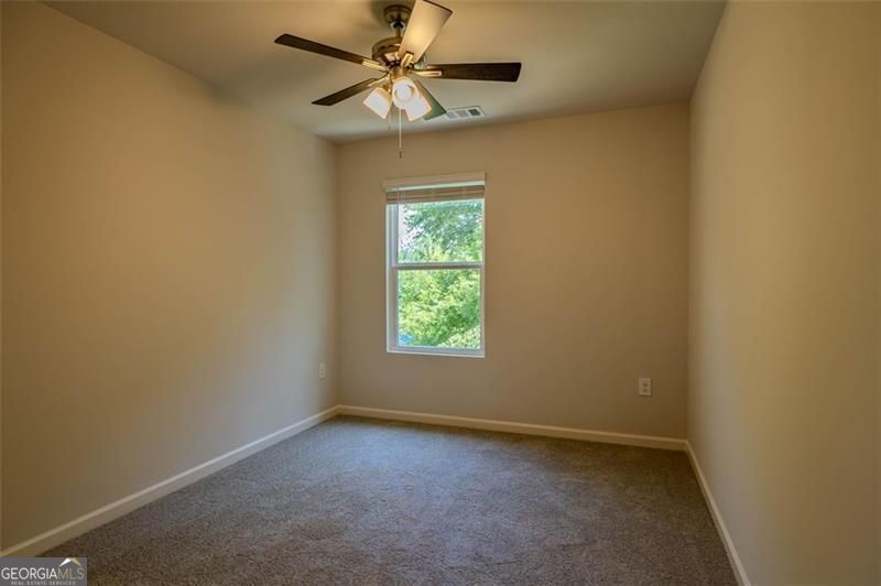 1005 North 2nd Avenue Northwest, Unit 31 Rome, GA 30165 - Photo 6 of 20 an empty room with a window and a fan