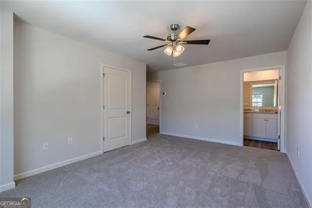 a view of an empty room and closet area