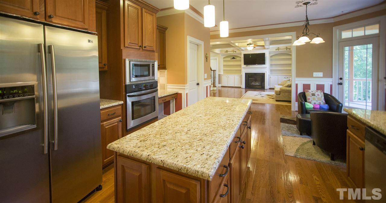 307 Ashdown Forest Lane Cary, NC 27519 - Photo 8 of 25 a kitchen with stainless steel appliances granite countertop a sink and refrigerator