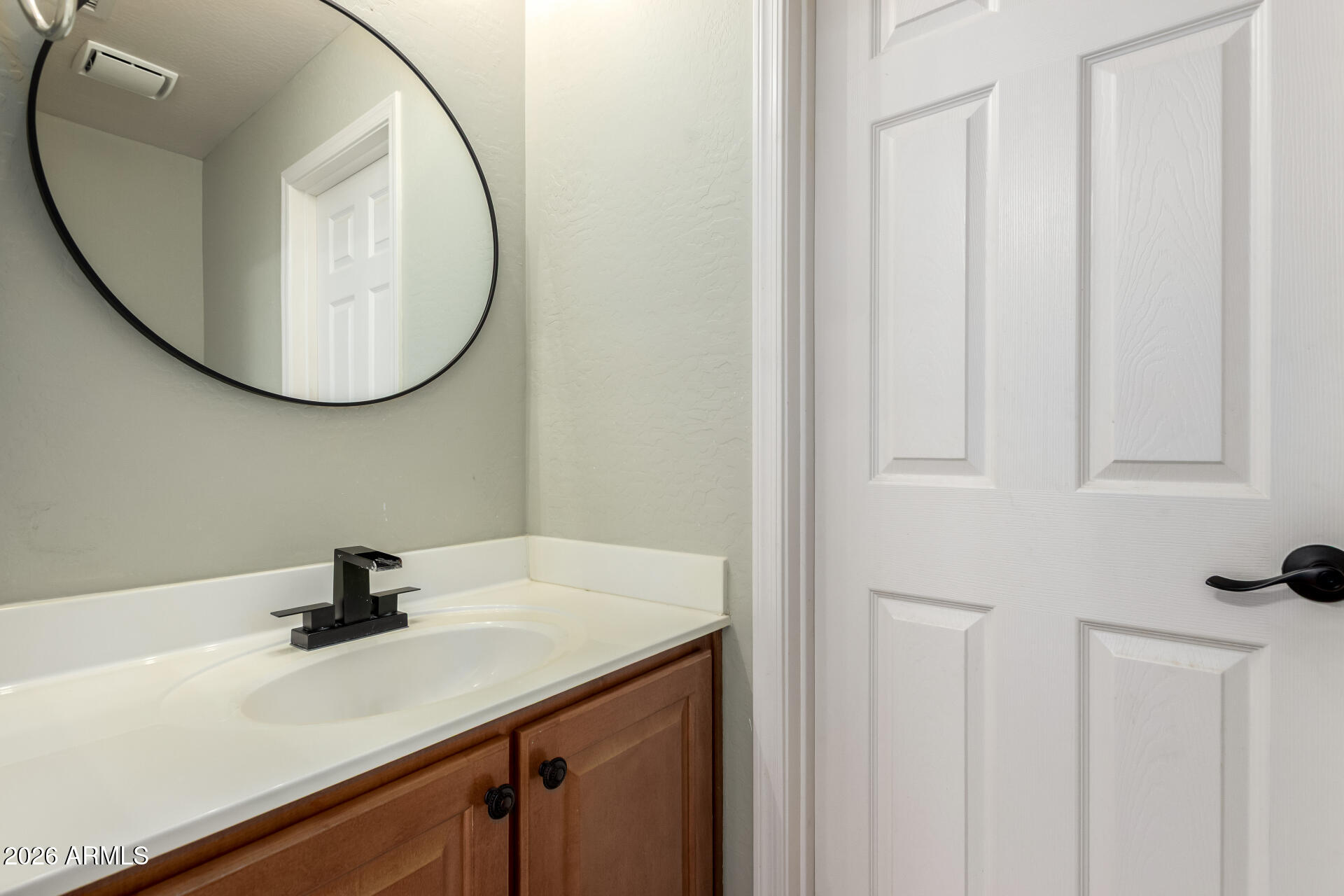 1491 East Rolls Road San Tan Valley, AZ 85143 - Photo 13 of 35 a bathroom with a sink a mirror and vanity