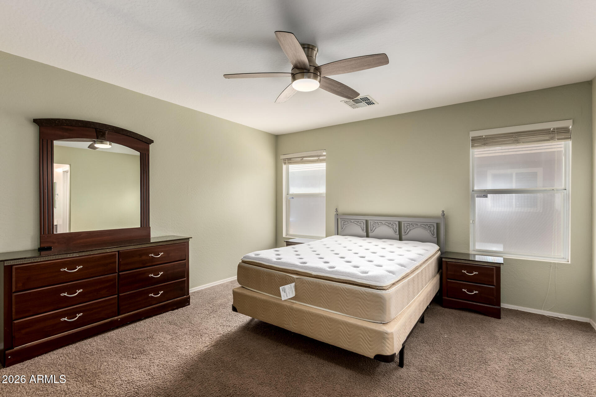 1491 East Rolls Road San Tan Valley, AZ 85143 - Photo 14 of 35 a bedroom with a bed and a dresser