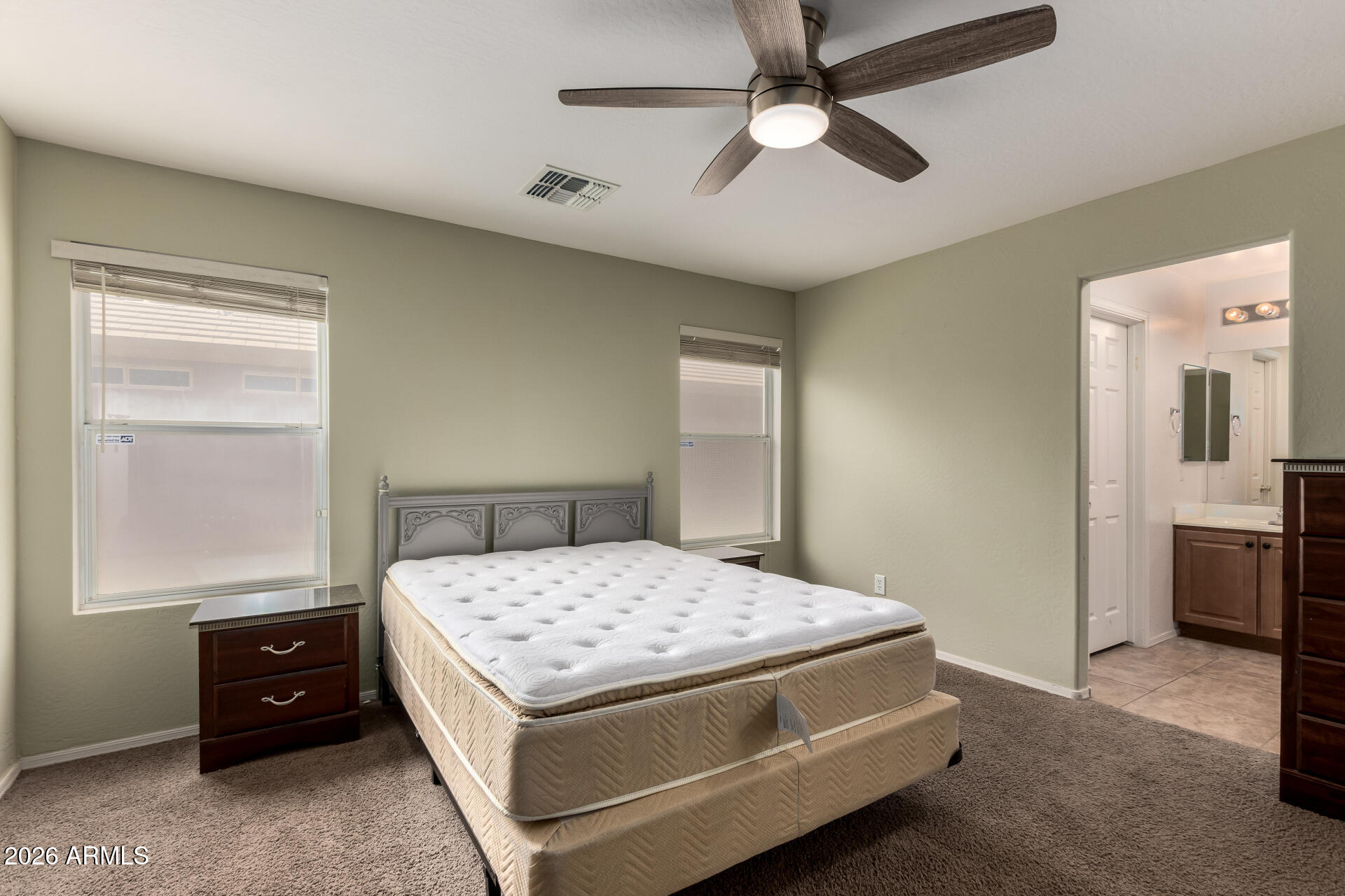 1491 East Rolls Road San Tan Valley, AZ 85143 - Photo 16 of 35 a bedroom with a bed and a chandelier