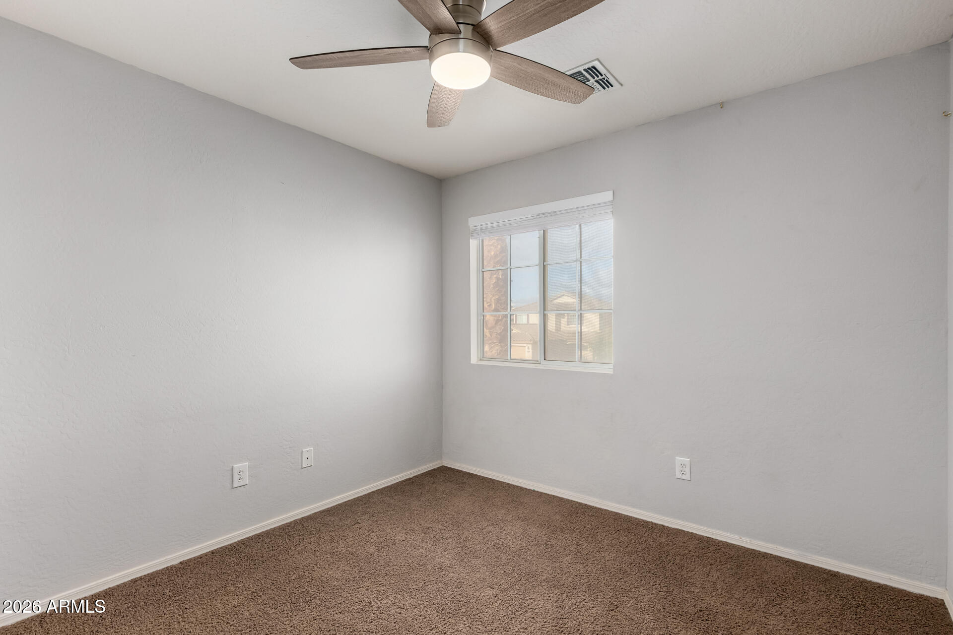 1491 East Rolls Road San Tan Valley, AZ 85143 - Photo 20 of 35 an empty room with a window and a fan