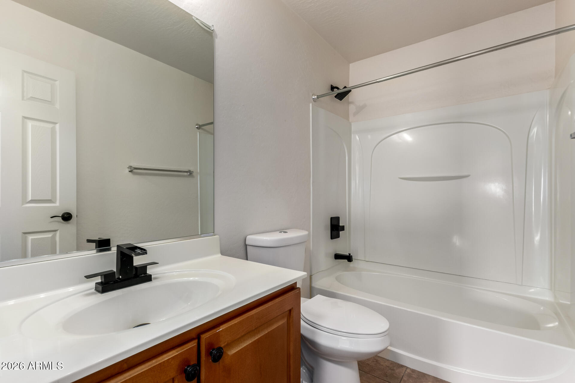 1491 East Rolls Road San Tan Valley, AZ 85143 - Photo 26 of 35 a bathroom with a sink a toilet and a mirror