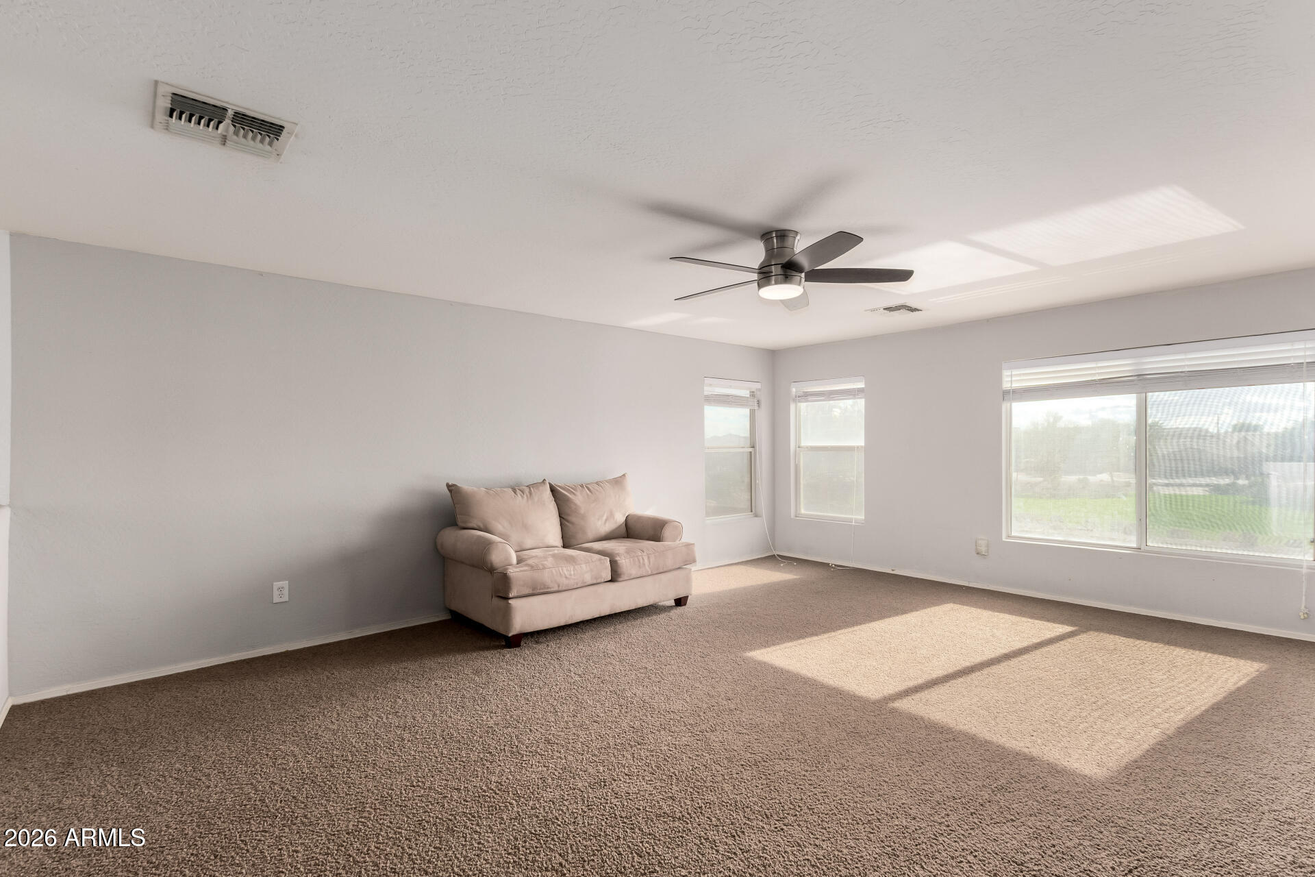 1491 East Rolls Road San Tan Valley, AZ 85143 - Photo 27 of 35 a living room with furniture and a ceiling fan