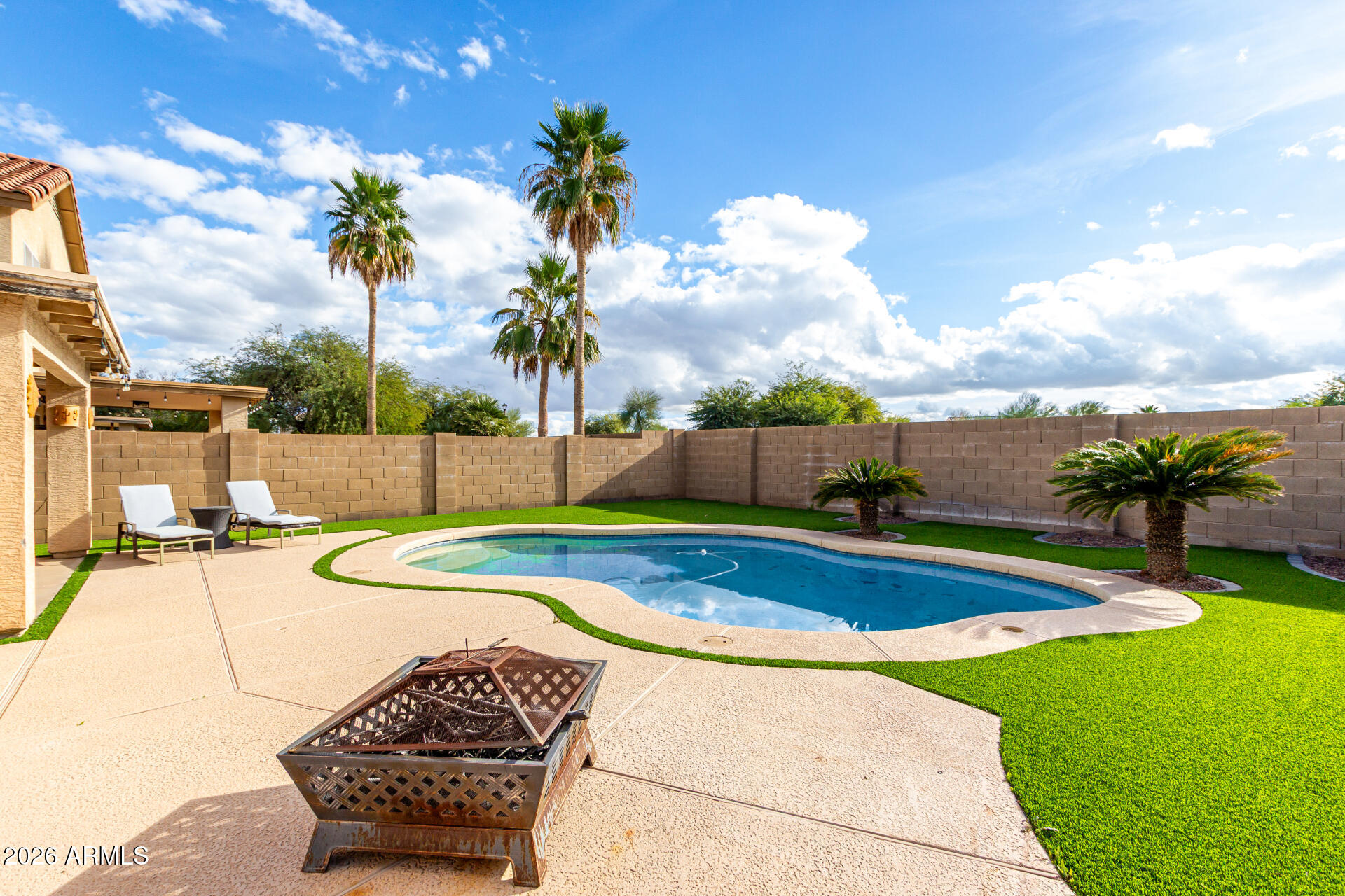 1491 East Rolls Road San Tan Valley, AZ 85143 - Photo 31 of 35 a view of a swimming pool with a yard