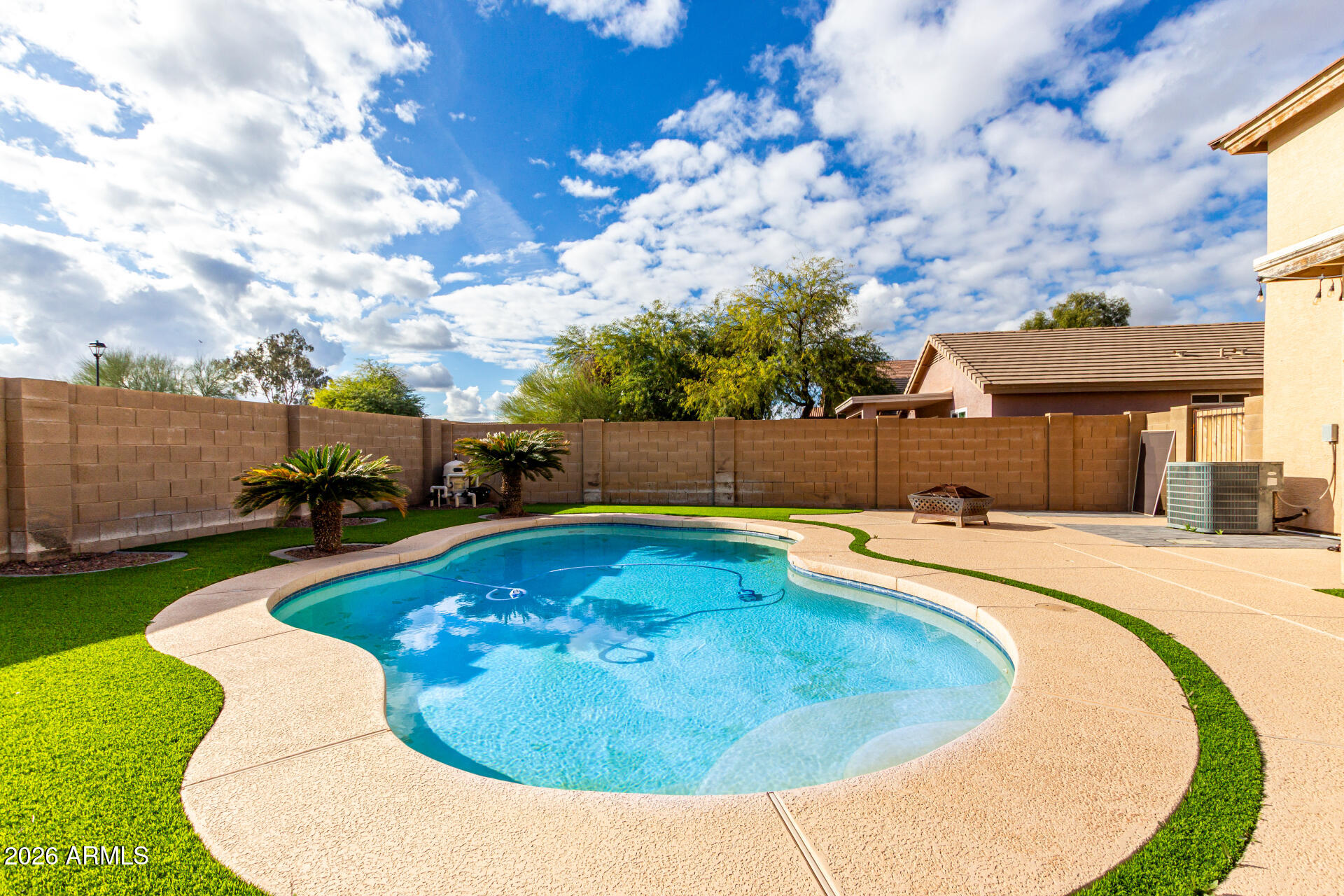 1491 East Rolls Road San Tan Valley, AZ 85143 - Photo 35 of 35 a swimming pool with outdoor seating and yard in back