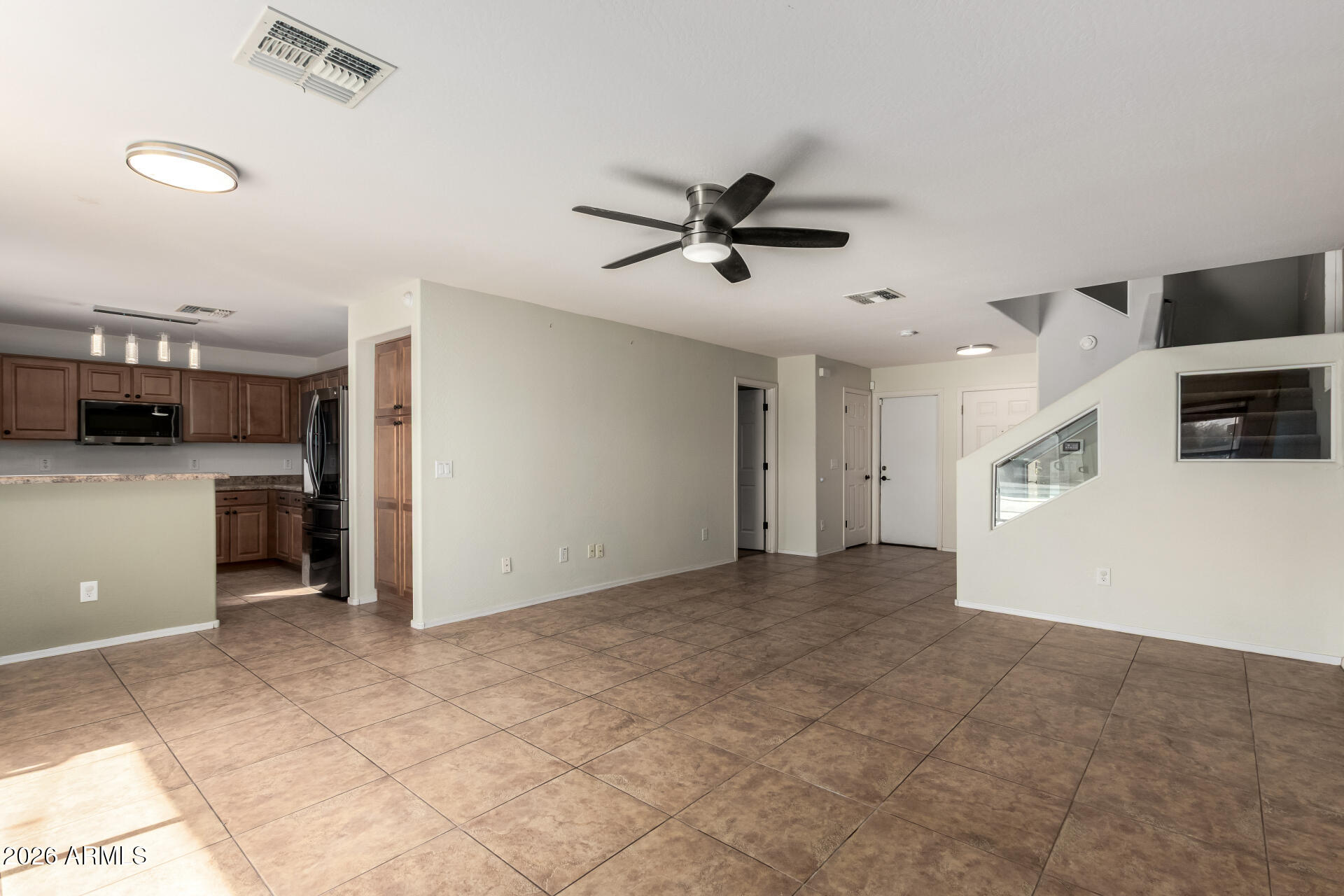 1491 East Rolls Road San Tan Valley, AZ 85143 - Photo 9 of 35 a view of a kitchen with a sink and a refrigerator