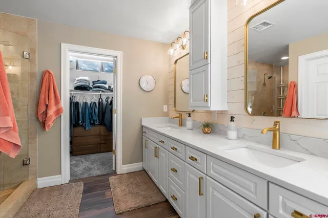 a bathroom with a double vanity sink and a mirror