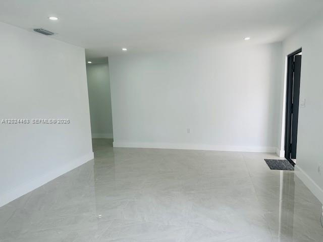11870 Southwest 5th Street, Unit 1 Miami, FL 33184 - Photo 5 of 38 an empty room with wooden floor