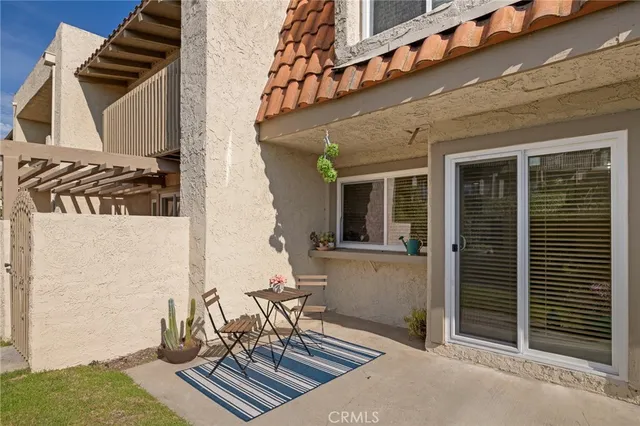 a view of a kitchen with a sink and dishwasher a refrigerator with white cabinets