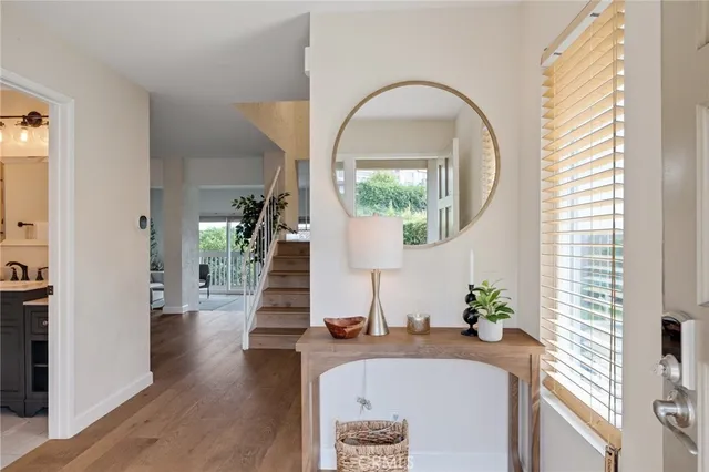 a kitchen with granite countertop white cabinets and a large window