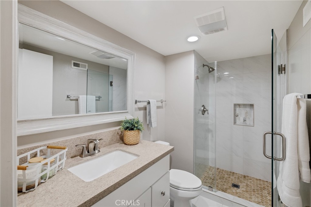 58 Hilltop Circle Rancho Palos Verdes, CA 90275 - Photo 44 of 51 a bathroom with a granite countertop sink toilet a shower and a mirror