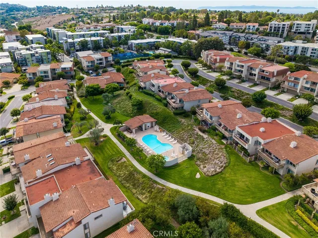a view of a house with pool and chairs