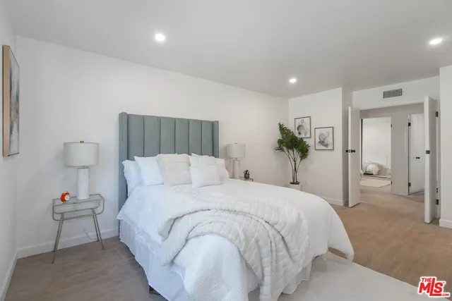 a bedroom with a bed and a lamp