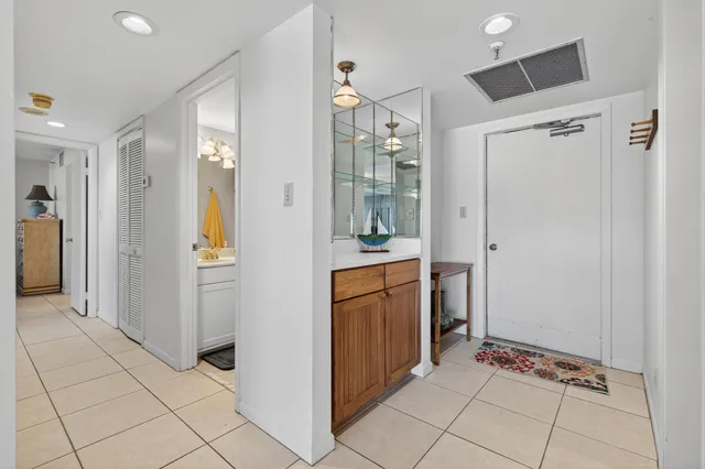 a view of a hallway and an dining rom with furniture