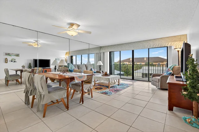 a living room with lots of furniture and a large window