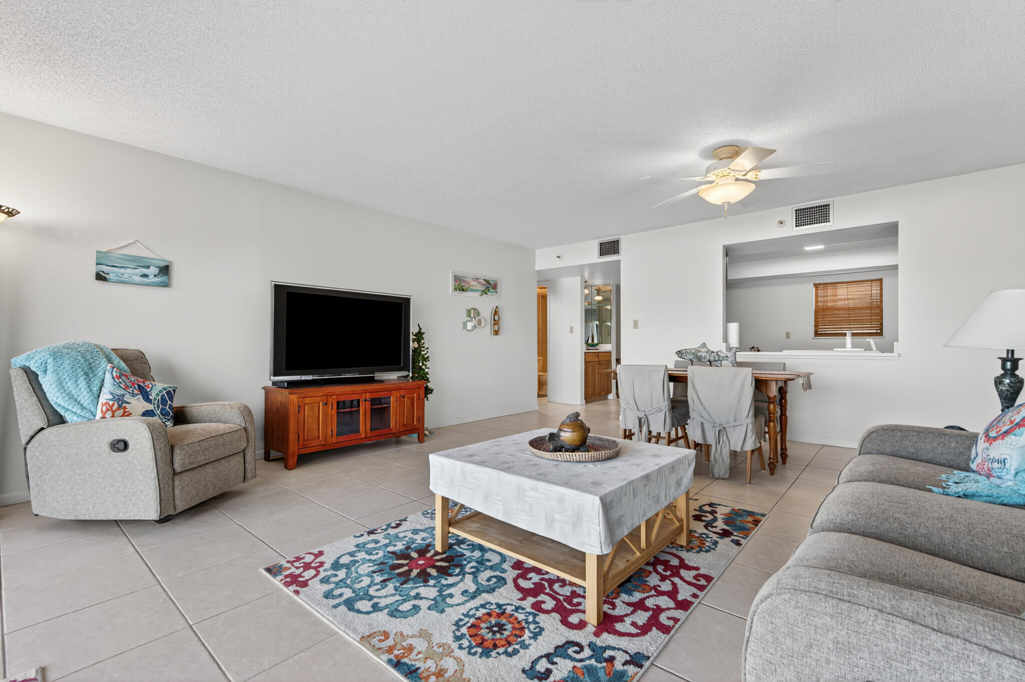 801 South Ocean Drive, Unit 404 Fort Pierce, FL 34949 - Photo 14 of 37 a living room with furniture and a flat screen tv