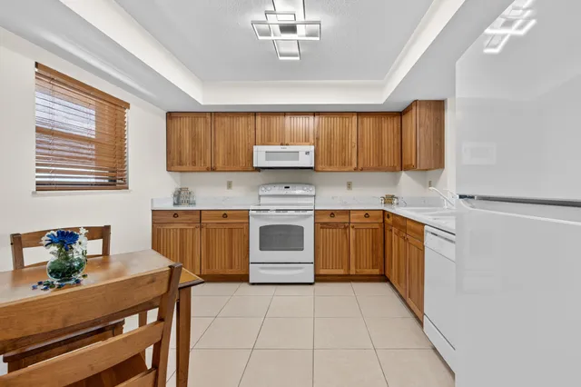a kitchen with a stove sink and cabinets