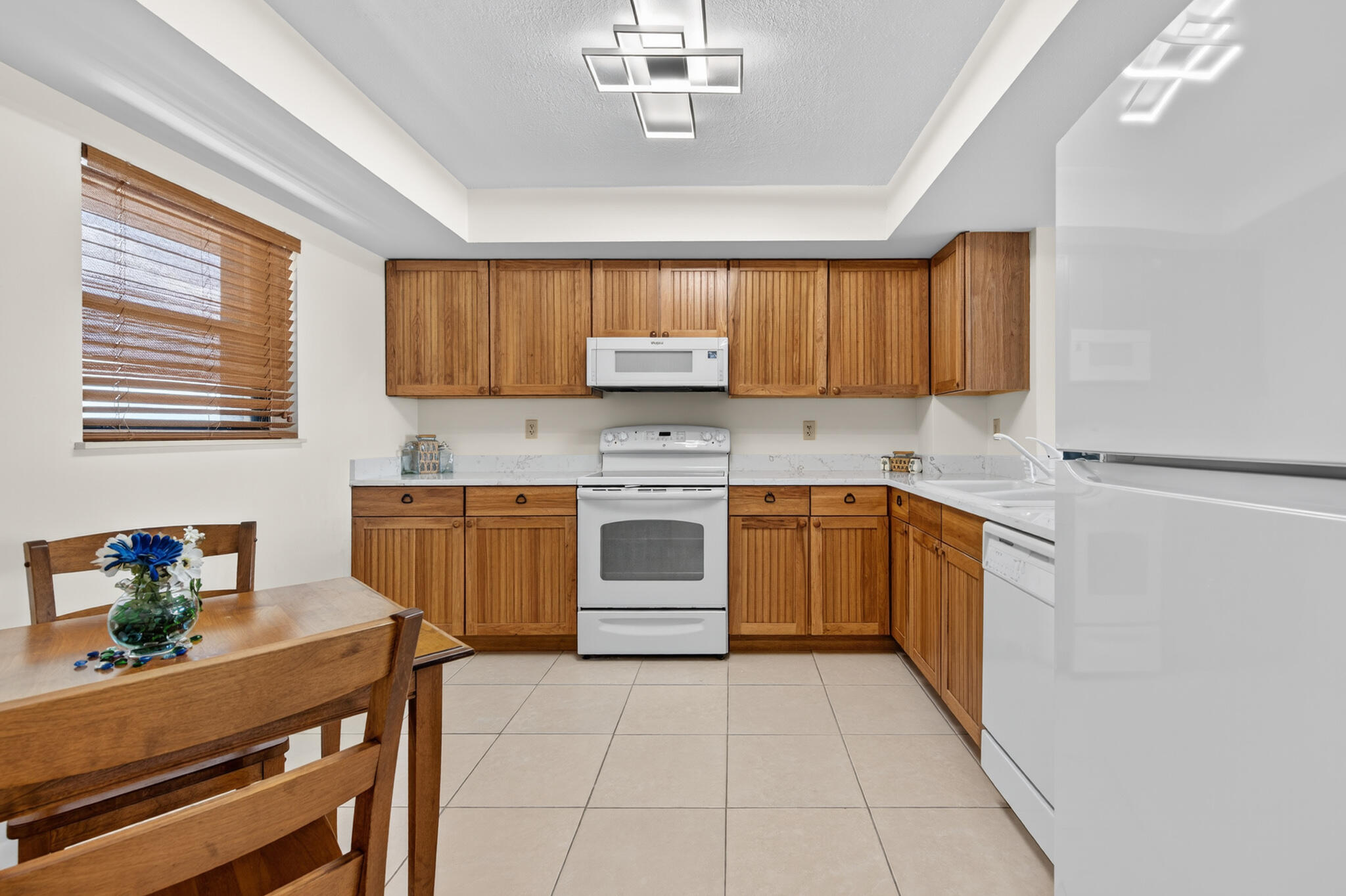 801 South Ocean Drive, Unit 404 Fort Pierce, FL 34949 - Photo 18 of 37 a kitchen with a stove sink and cabinets
